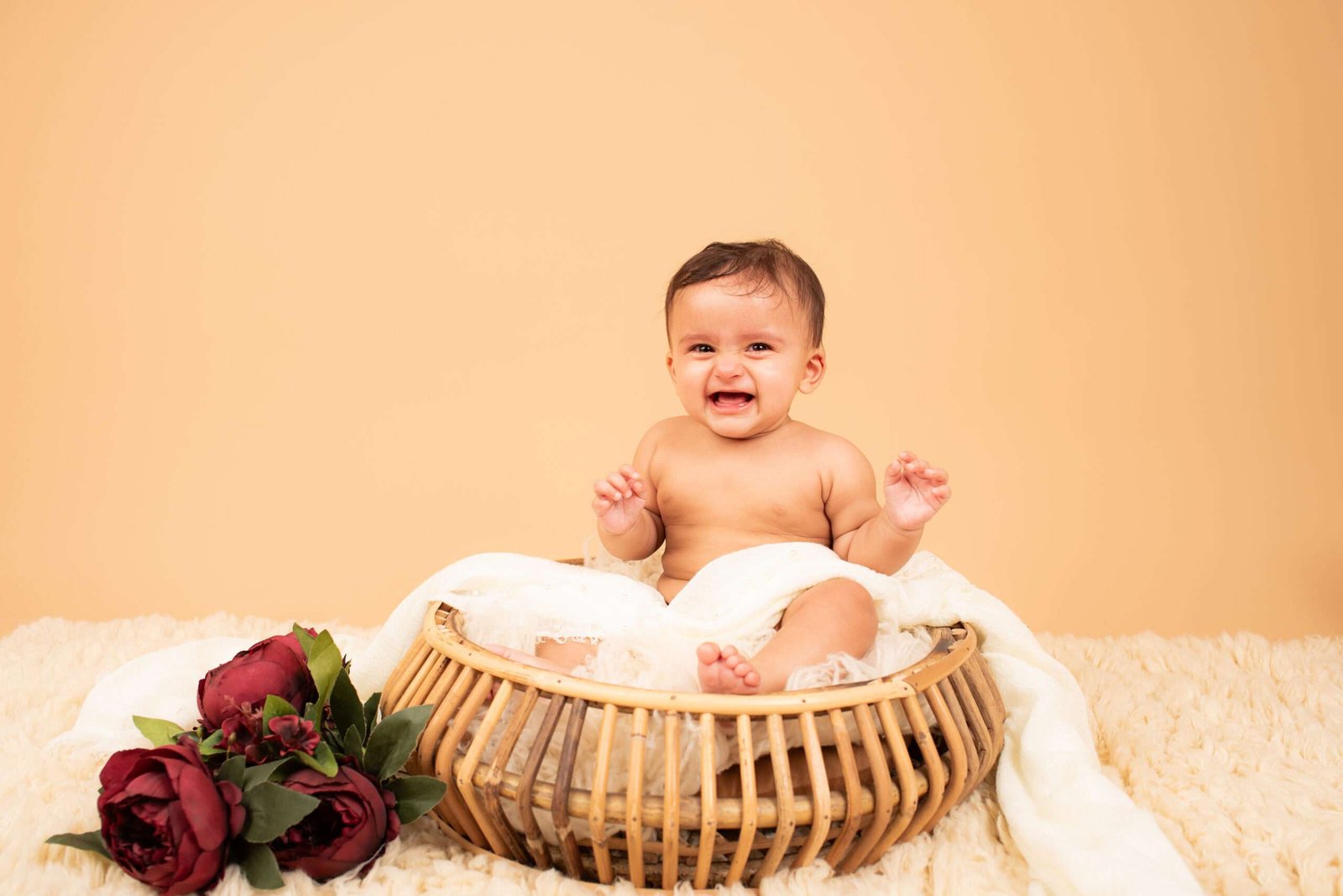 Toddler laughing during a milestone studio portrait session